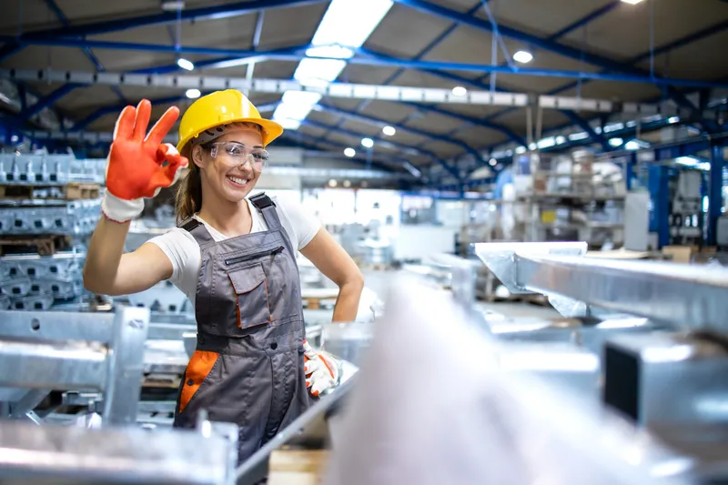 Factory worker giving an OK sign on the shop floor