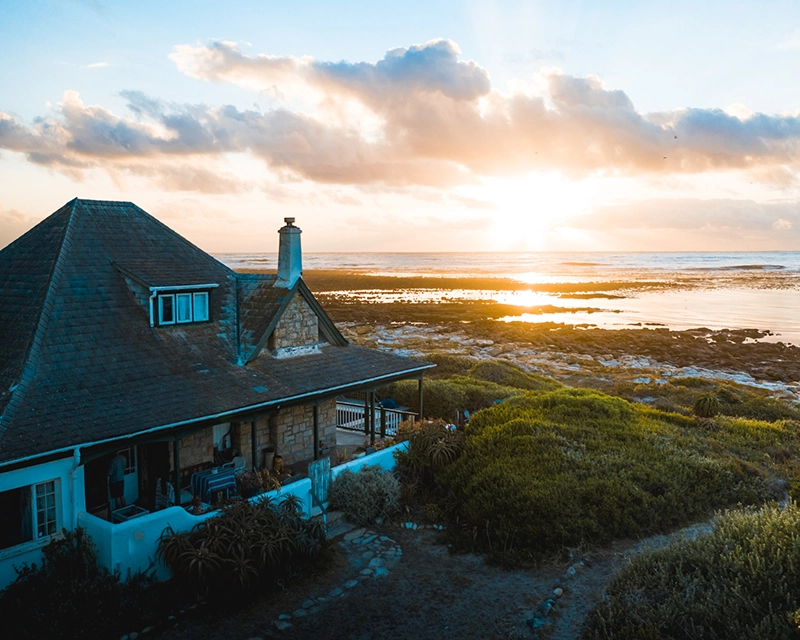Beach house overlooking the ocean at sunset