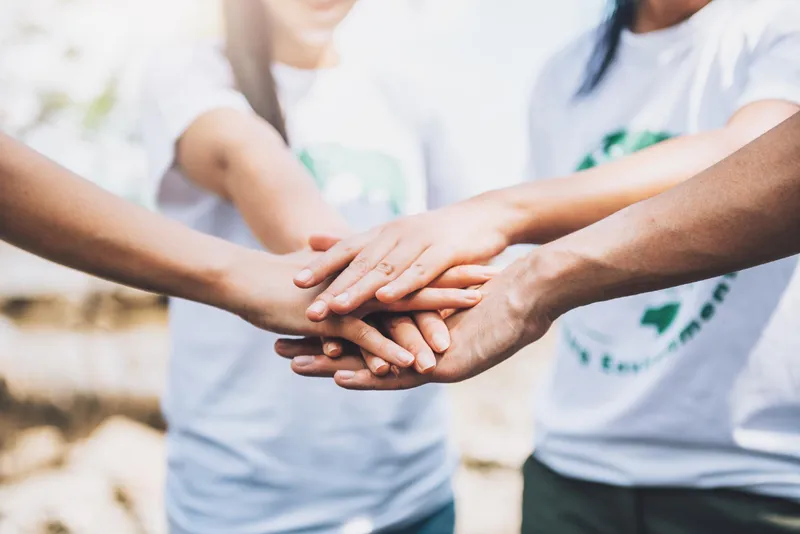 Volunteers stacking their hands together